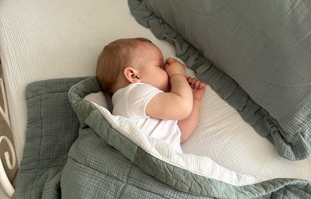 Baby Lying Down in Crib and Sleeping