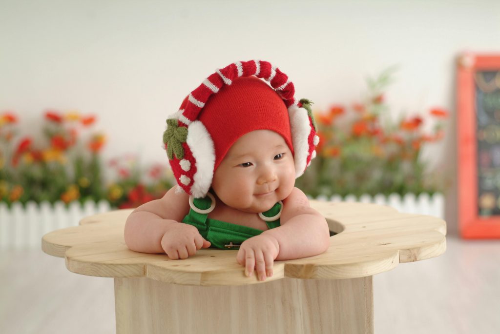 Baby in a Red Cap and Earmuffs