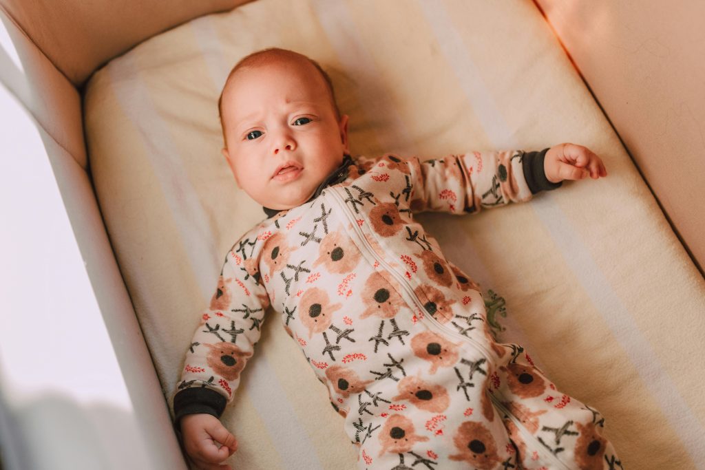 A Baby Lying in a Crib