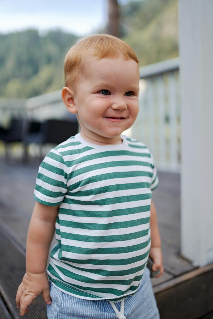 Shy smiling little boy on terrace