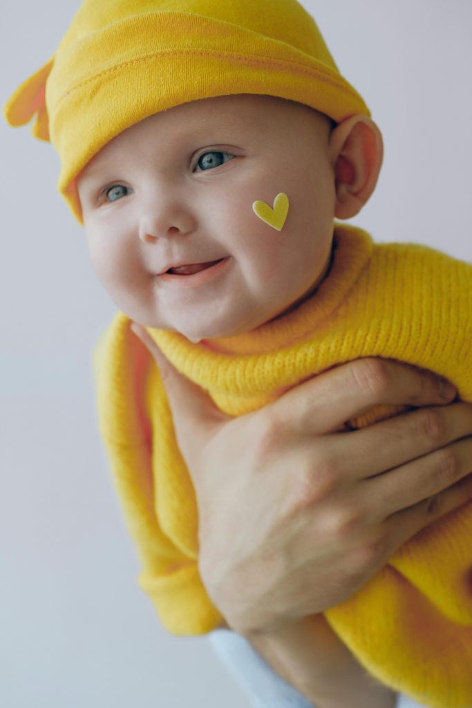 Baby in Yellow Knit Cap and Yellow Knit Sweater