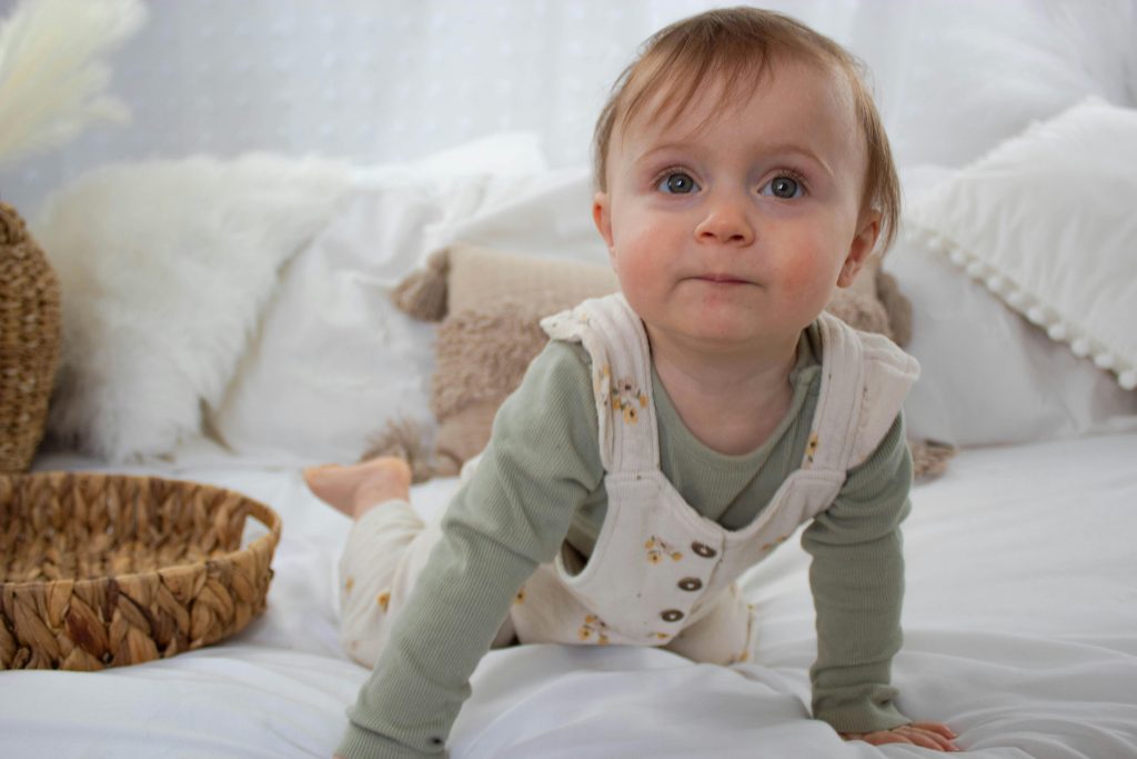 Boy in Overalls on Bed