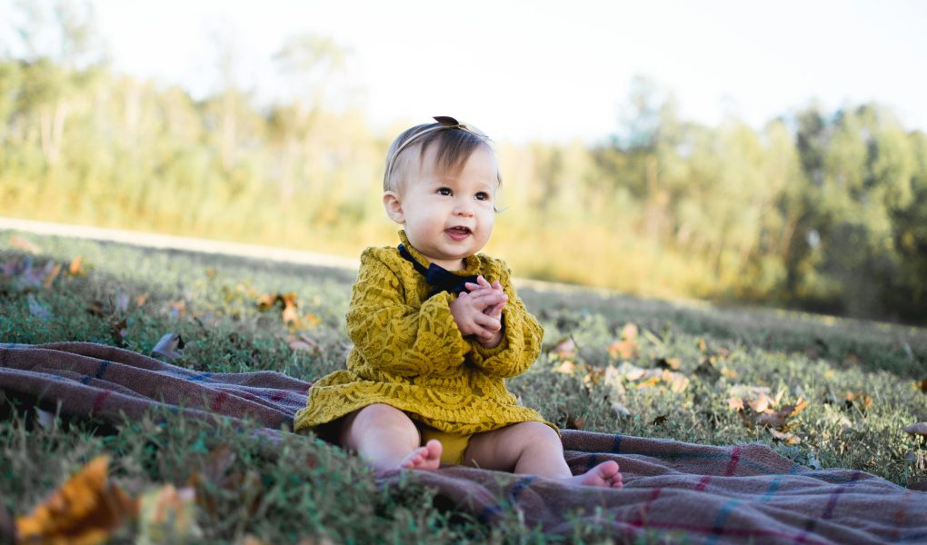 Baby Wearing Yellow Crochet Long Sleeve Dress Sitting on Brown Textile - Featured