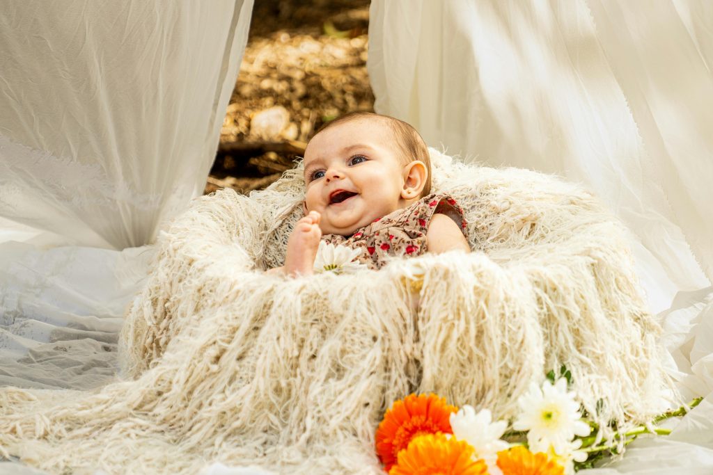 Smiling Baby Lying Down in Basket