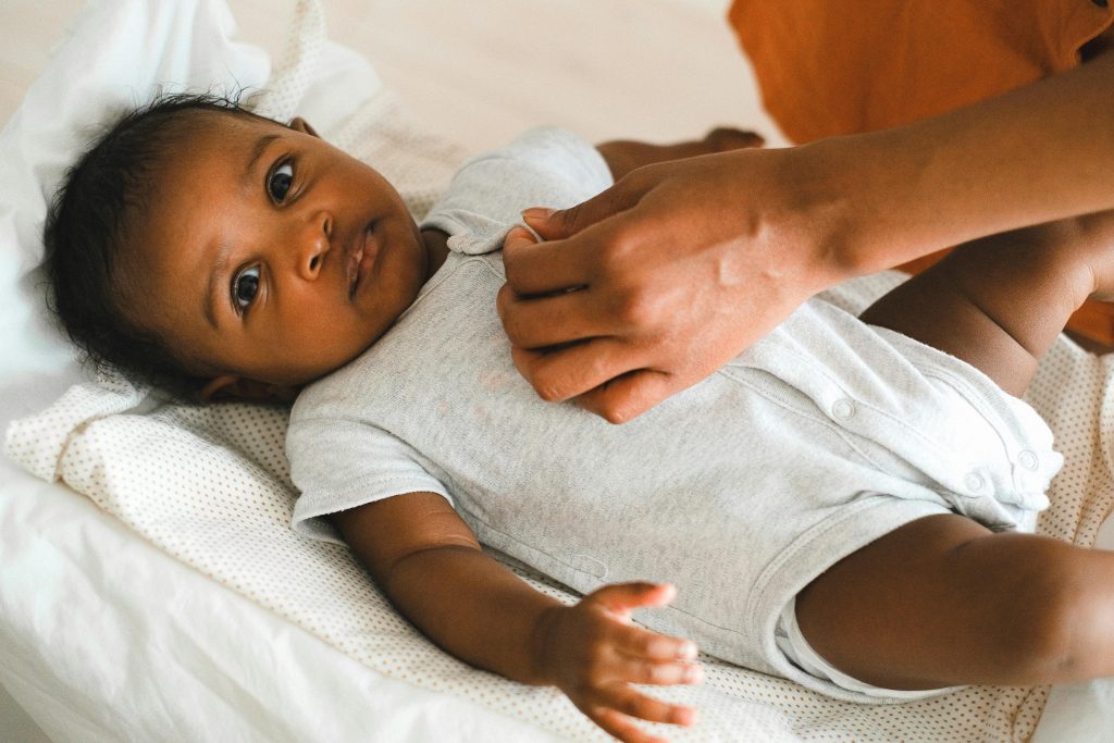 Mother Dressing Her Baby