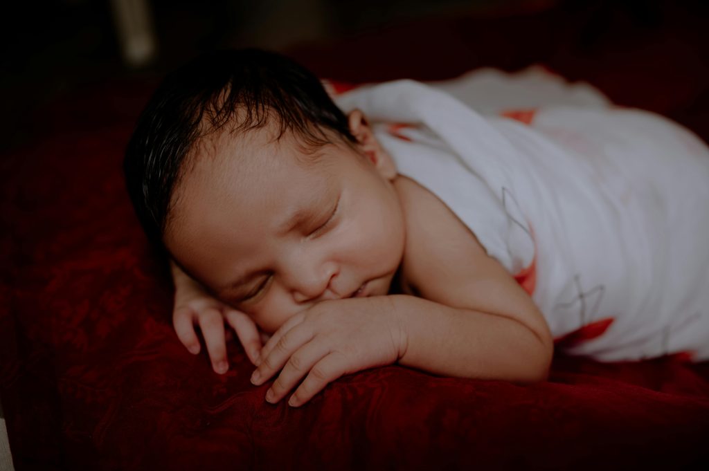 Peaceful Sleeping Baby Portrait on Red Blanket