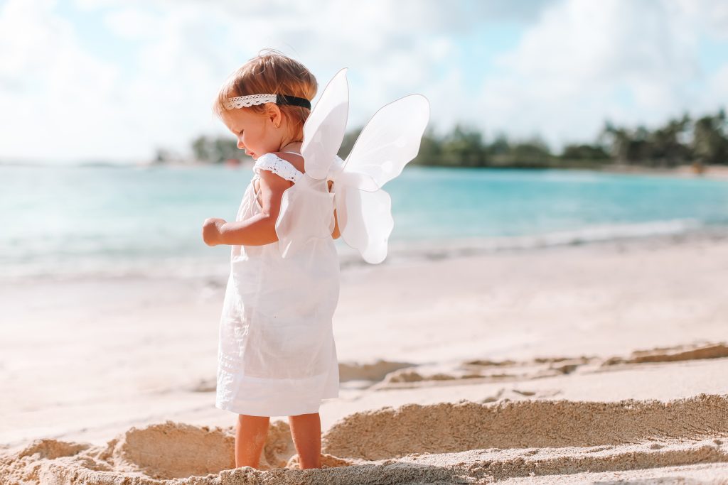 Baby standing on beach