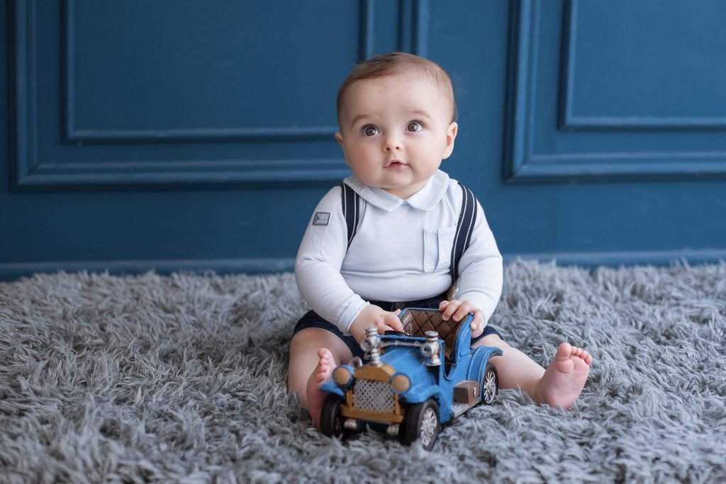 100 Modern Boy Names With Cool Nicknames 8 Cute toddler sitting playing with car