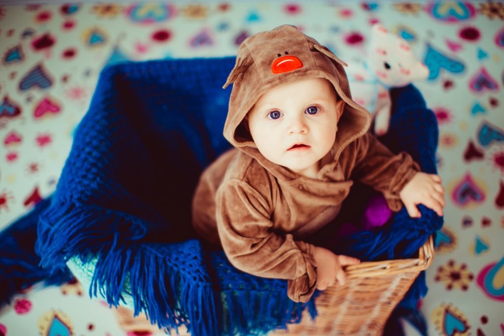 100 Modern Boy Names With Cool Nicknames 10 Little baby sits in a wicker basket