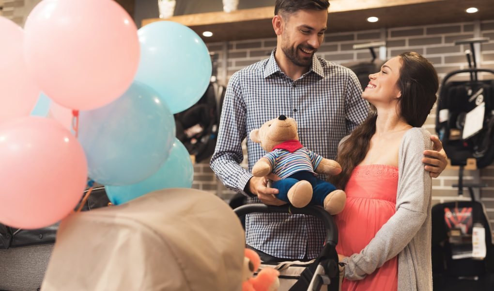 Pregnant WOman holding a bear during baby shower celebration