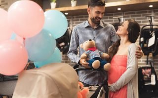 Pregnant WOman holding a bear during baby shower celebration