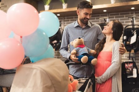 30 Winnie The Pooh Baby Shower Theme Ideas Worth Stealing 3 Pregnant WOman holding a bear during baby shower celebration
