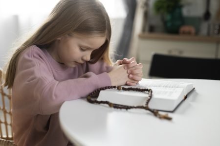 girl praying at home