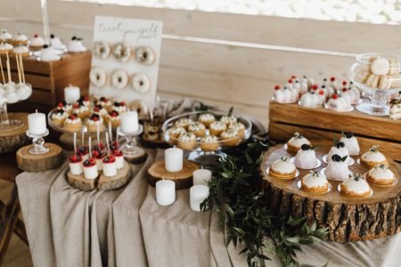 25 Mini Dessert Ideas for a Joyful Baby Shower 9 Table full of sweet delicious desserts, cupcakes, donuts and panna cotta desserts