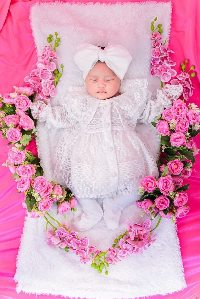 30+ Unique Baby Shower Gift Ideas for Expecting Mamas 51
A baby is laying on a blanket with a sign that says baby