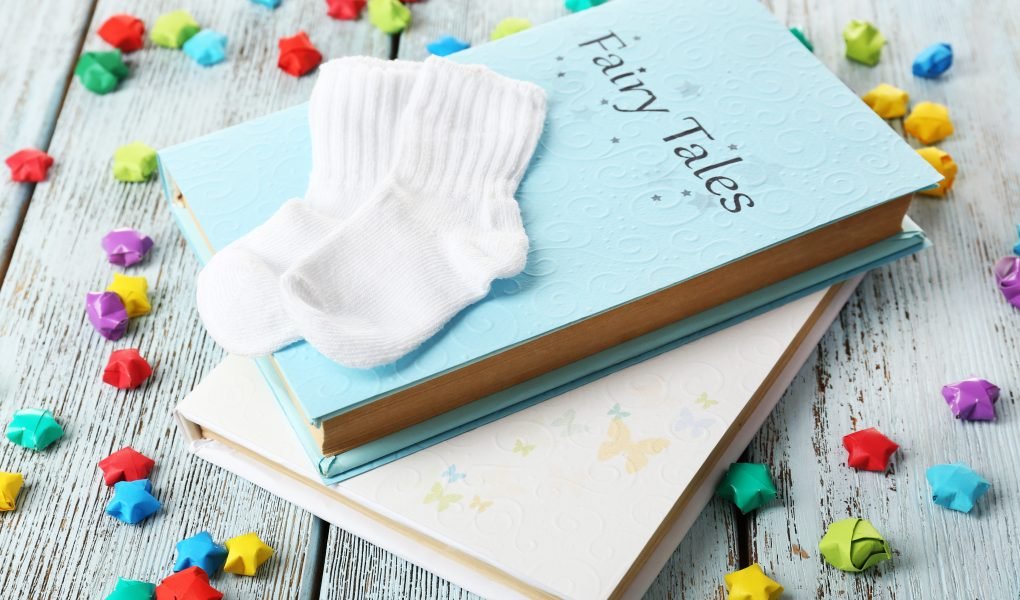 30 Unique A New Chapter Baby Shower Theme Ideas That Feel Like Home 1 Fairy tales on wooden table