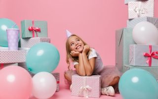 Pretty little girl in a birthday hat celebrating