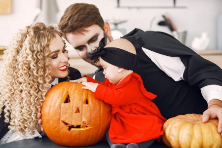 Mother father and children in halloween costumes and makeup